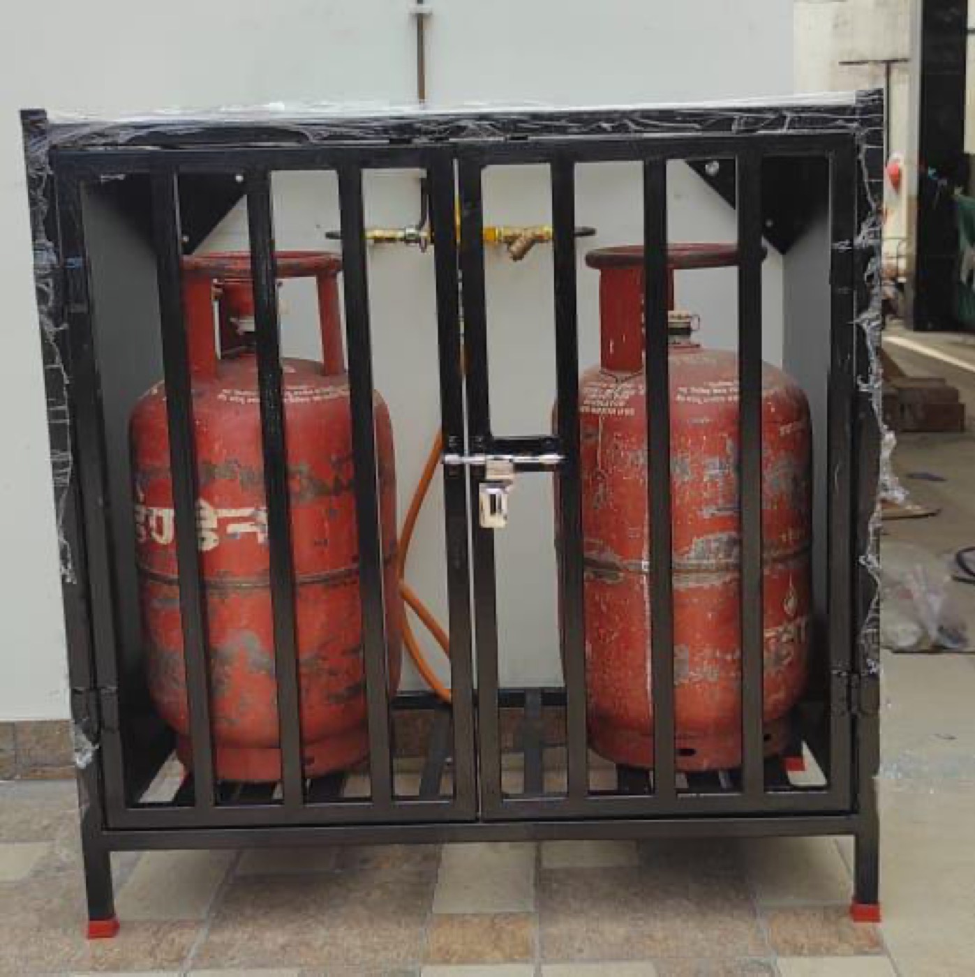 Secured and locked LPG cylinder bank enclosure